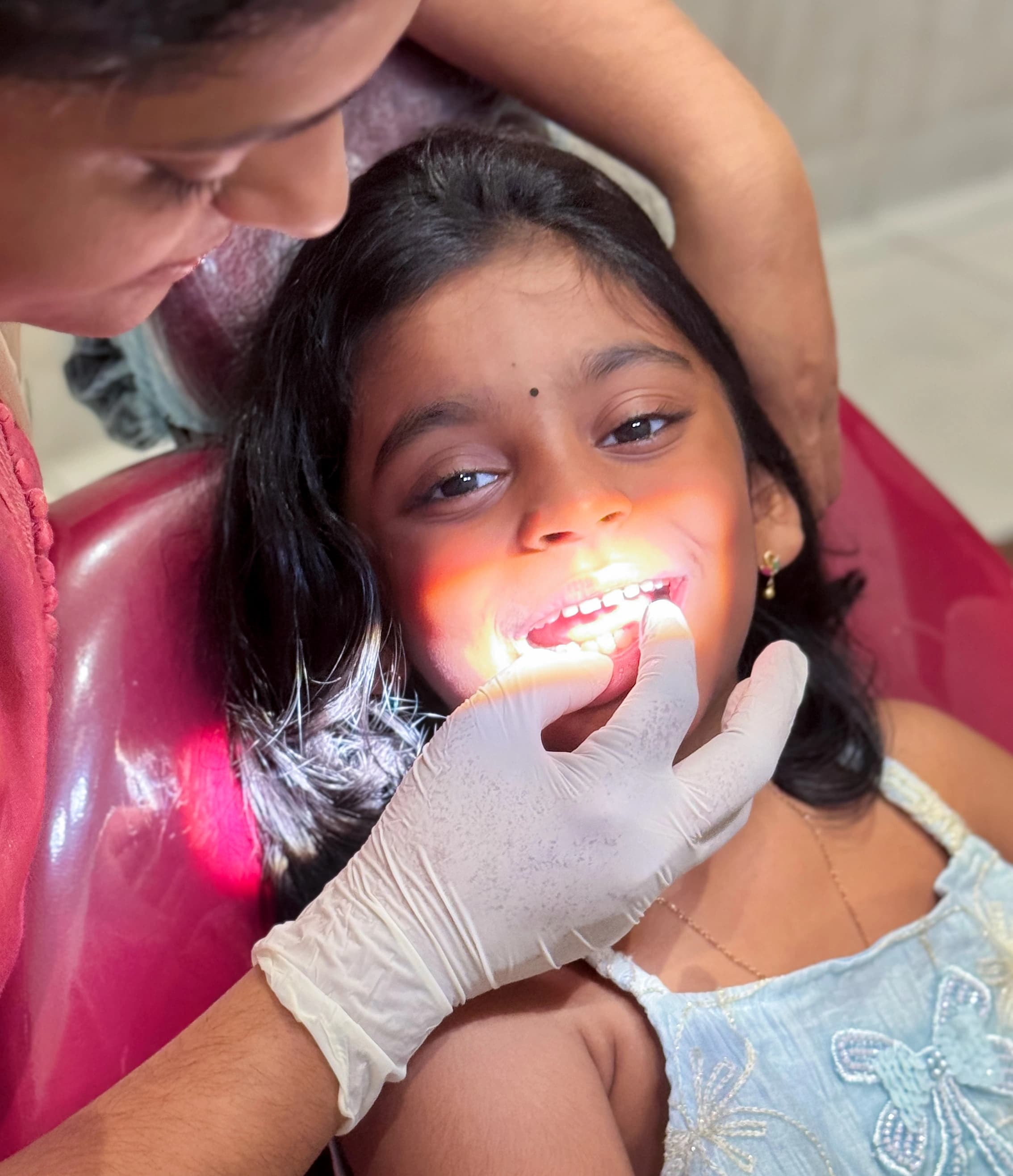 dentist checking cavity of kid